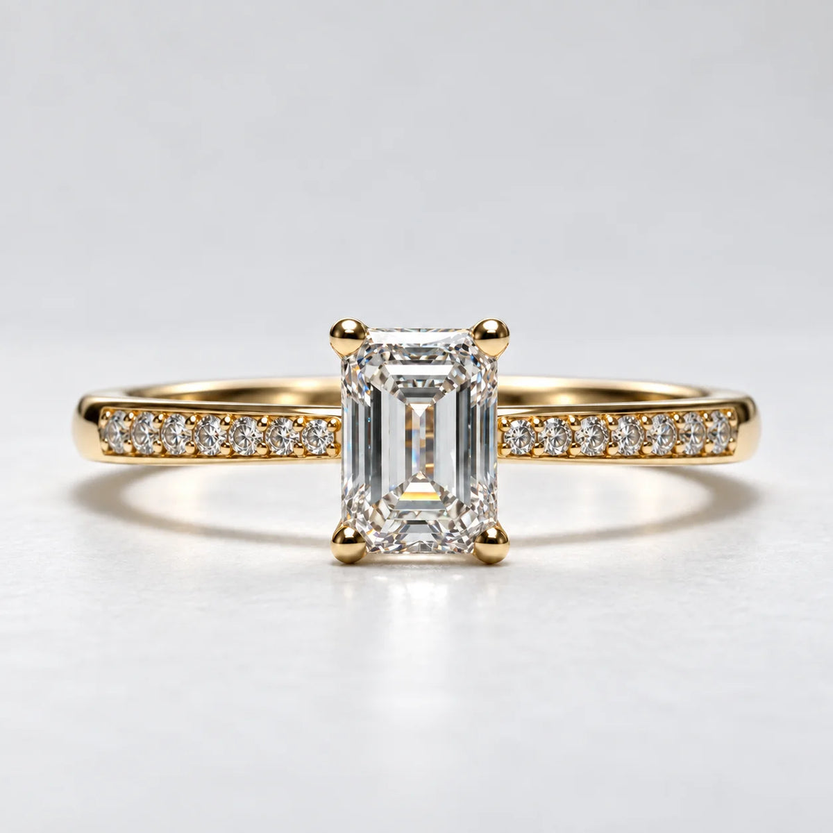 Solitairering fra Petersen Jewels i 14 kt guld med 0,75 ct smaragdslibet labgrown diamant og 14 mindre sidesten, alternativ frontvinkel [ai-redigeret]